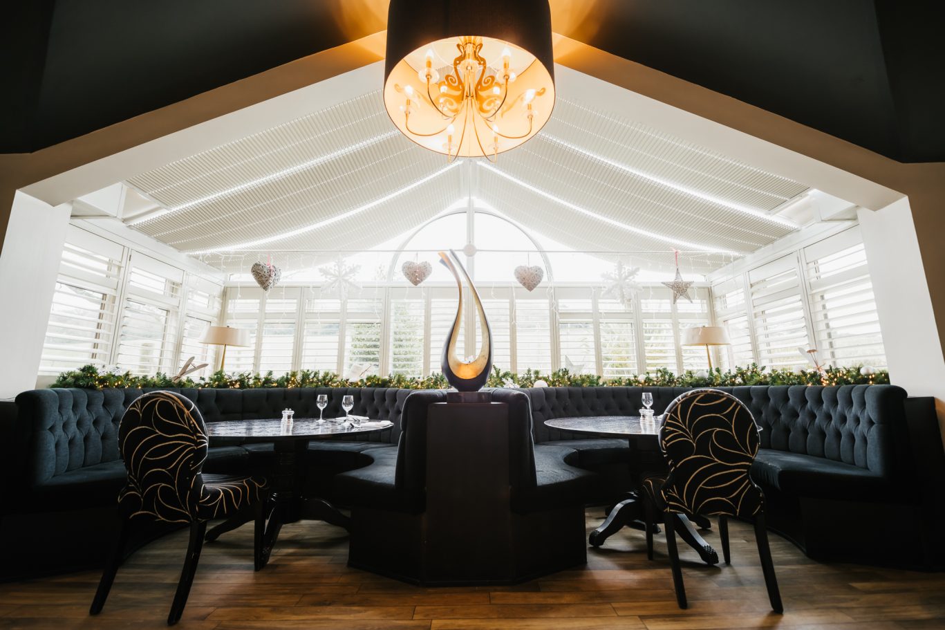 round tables with curved seating and curved ornament in the middle