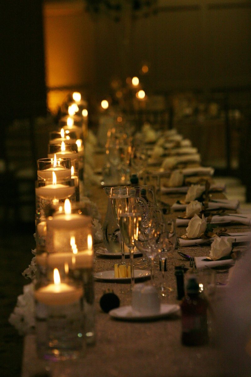 wedding top table in the dark with floating candles along the front