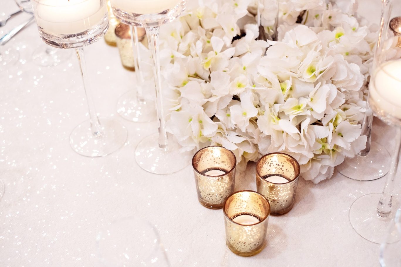 wedding table close up of white decorative flowers and tea light holders