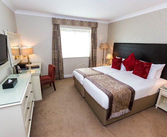 Family room with mounted tv, dressing table and chest of drawers