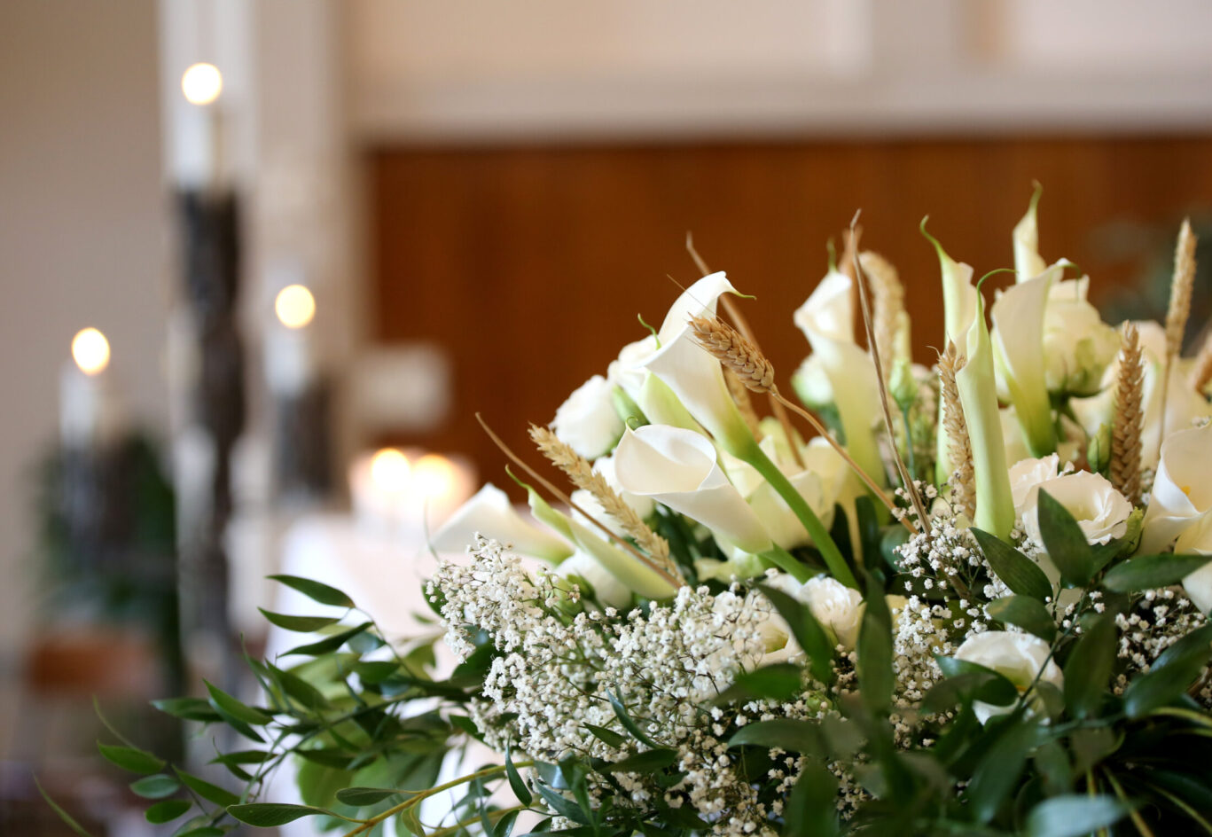 flowers on an altar in the church and the candles on background