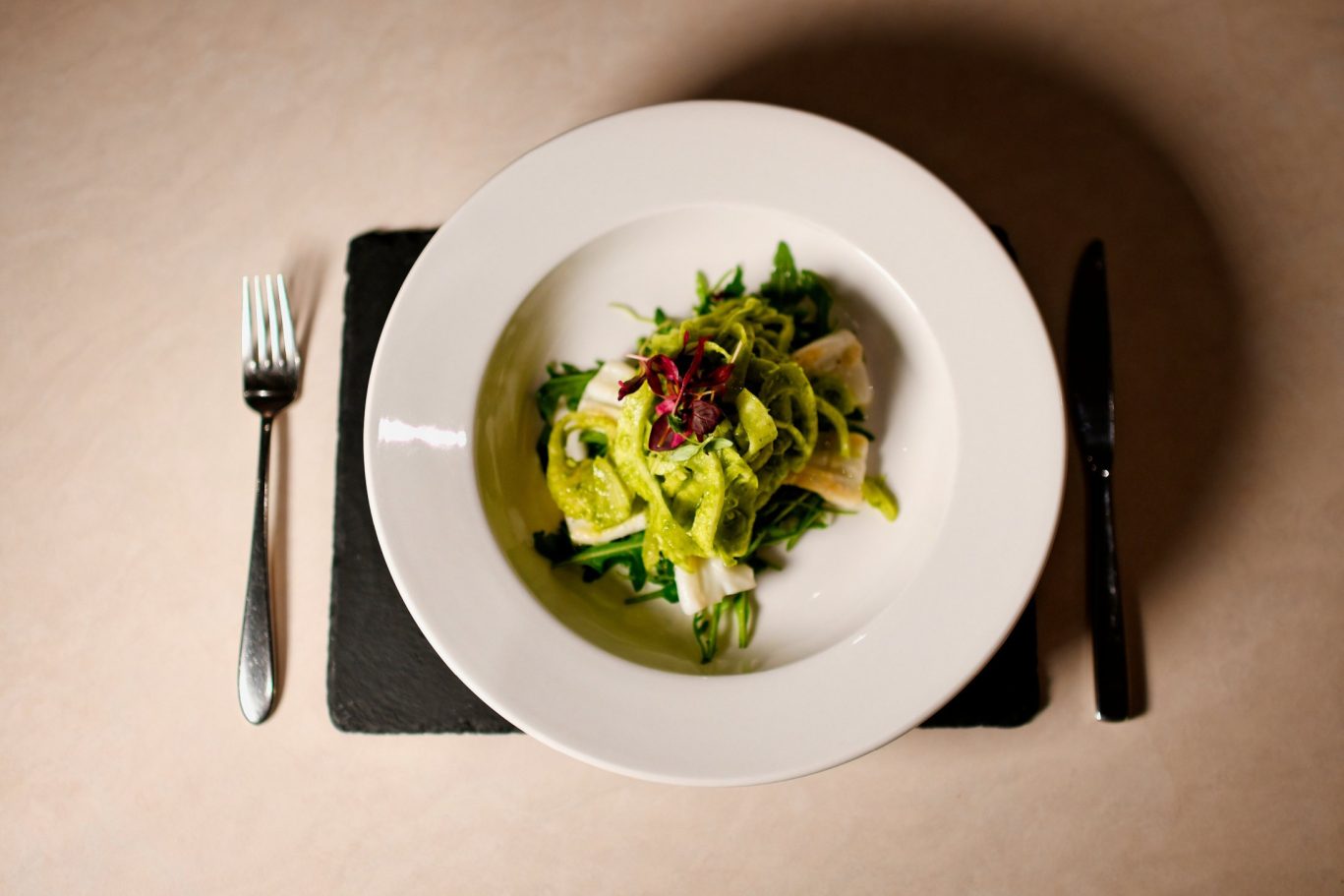 above shot of pesto pasta and halloumi in large bowl at melange restaurant