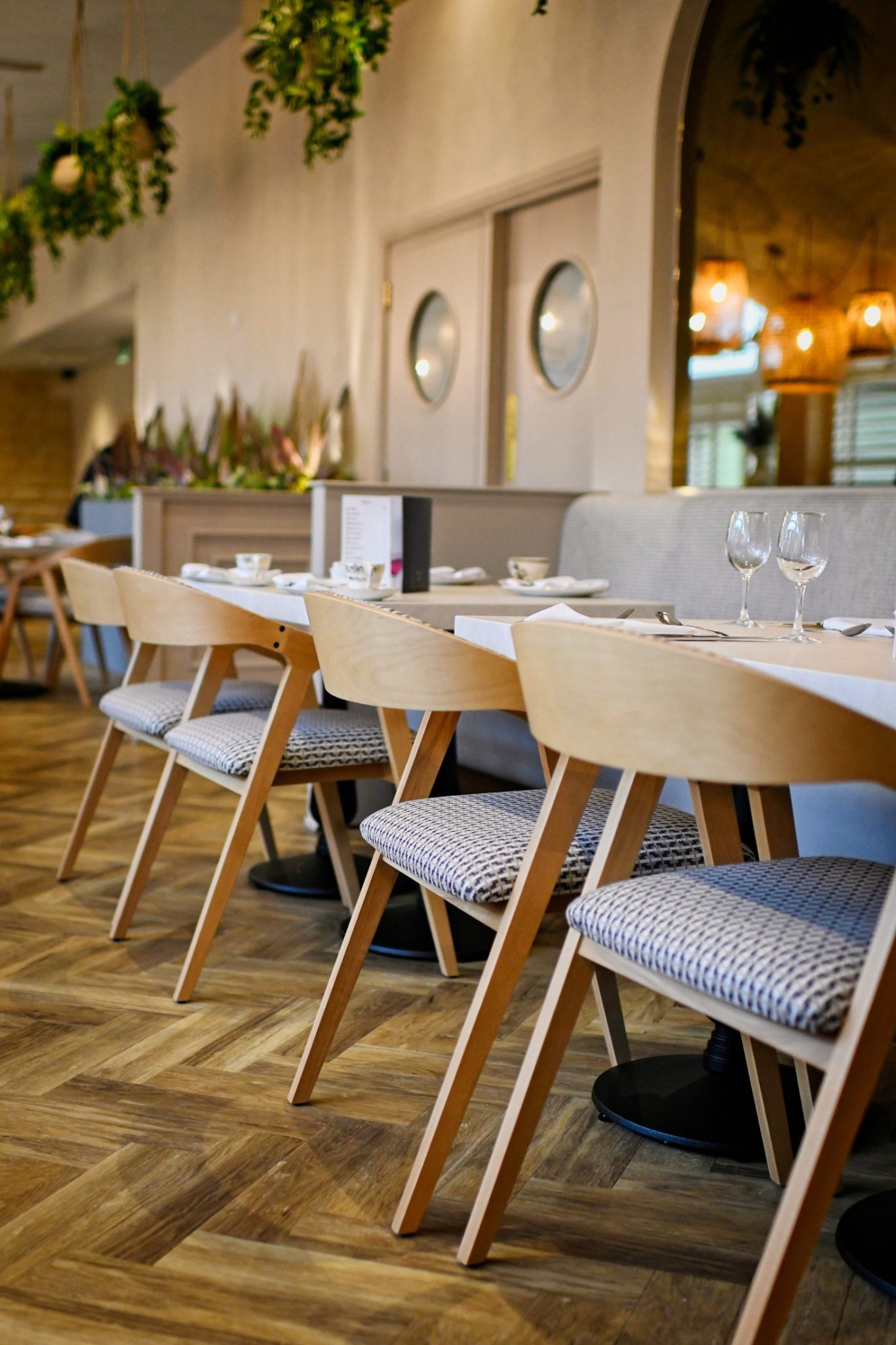 chairs lined up in front of two person tables
