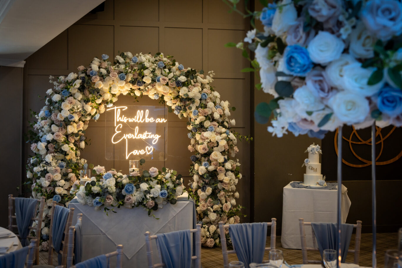 Flower archway statement decoration with neon lighting reading 