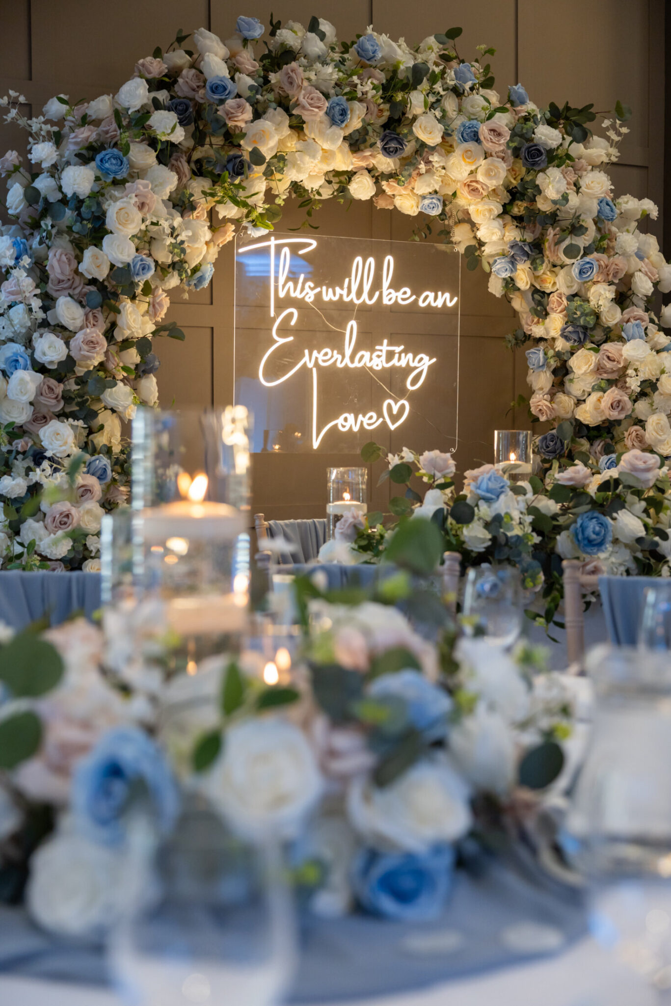 Flower archway statement decoration with neon lighting reading 